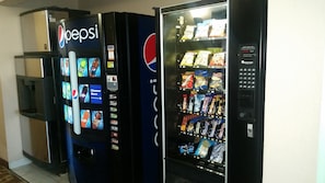 A vending machine with Pepsi branding and a selection of snacks.