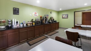 A breakfast bar with a coffee machine, a clock, and a menu board. - Super 8 by Wyndham Munfordville KY (Munfordville)