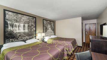 A hotel room with two beds, a desk, a TV, and a large waterfall painting on the wall.
