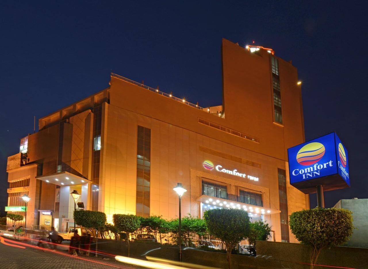 A Comfort Inn hotel with a modern design, featuring a prominent signage and well-lit entrance.