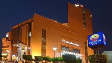 A Comfort Inn hotel with a modern design, featuring a prominent signage and well-lit entrance.