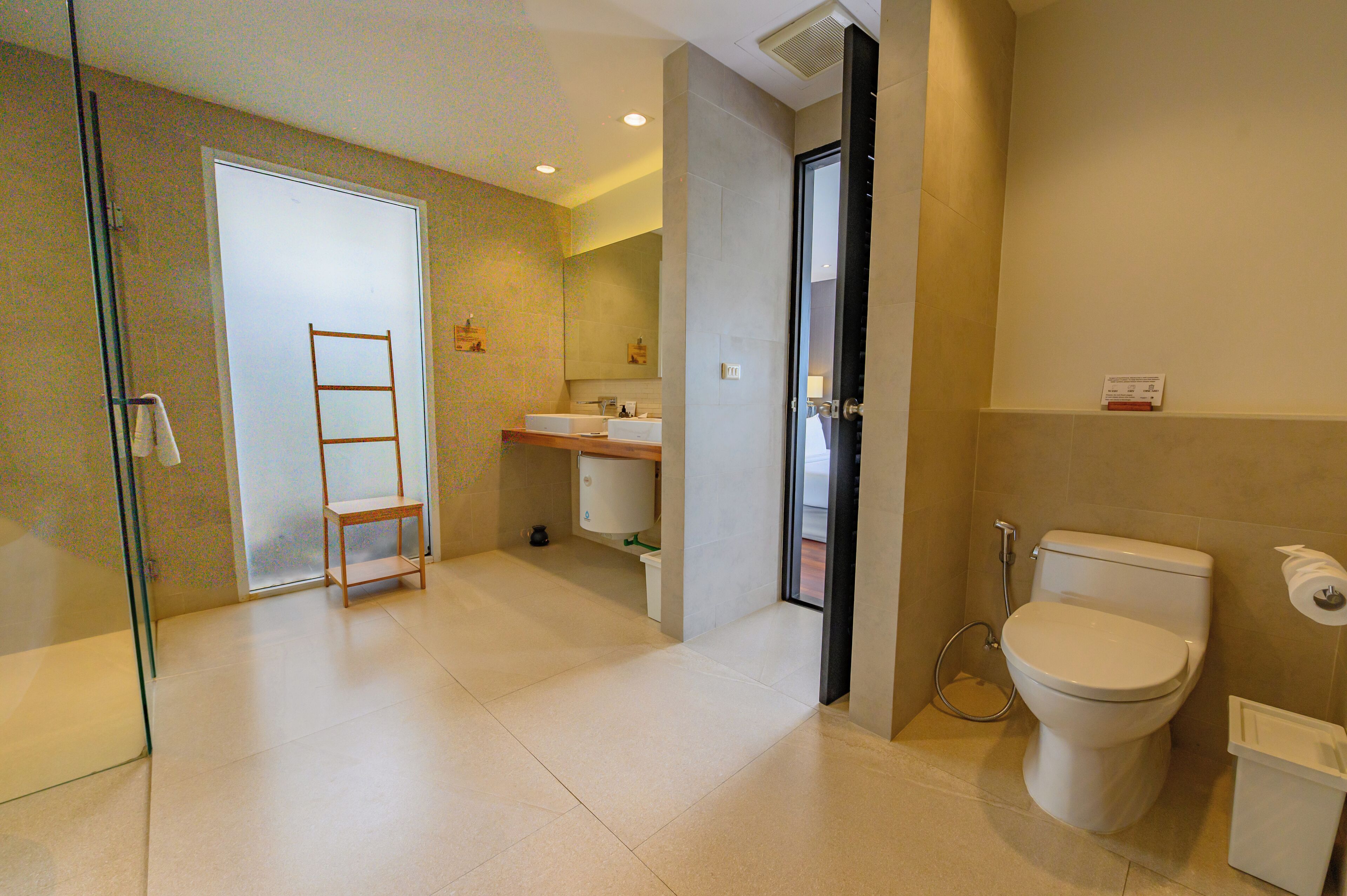 A modern bathroom with a toilet, bidet, and sink.