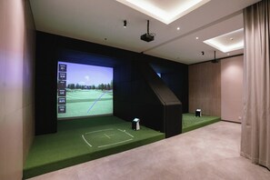 A modern home theater with a large screen, a projector, and a speaker system. - Delonix Hotel Karawang (Karawang)