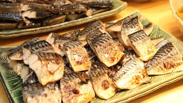 A variety of grilled fish on plates.