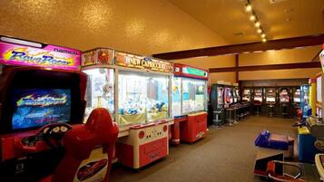 Enjoy classic arcade games like Rave Racer and New Capriccio in our gaming arcade.