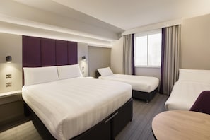 A hotel room with two beds, a desk, and a chair. - Premier Inn Manchester M56/J6 Runger Lane South (Altrincham)