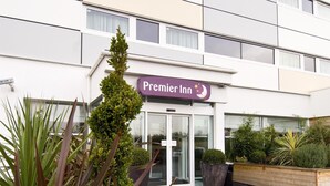 A hotel entrance with a sign reading 'Premier Inn' and a revolving door. - Premier Inn Manchester M56/J6 Runger Lane South (Altrincham)