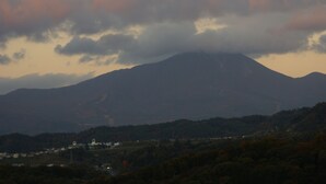 A mountain landscape with a town in the foreground. - Aizuwakamatsu Washington Hotel (Aizuwakamatsu)