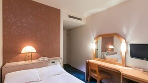A hotel room with a bed, desk, chair, TV, and a phone. - Aizuwakamatsu Washington Hotel (Aizuwakamatsu)