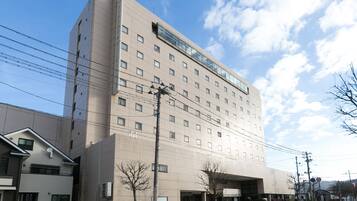 Hotel features a modern facade with a covered entrance and evenly spaced windows.