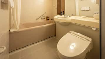 A bathroom with a bathtub, toilet, sink, and a mirror.