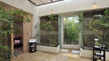 Relax in a serene space with a view of lush greenery, a relaxation room, and a tranquil seating area.