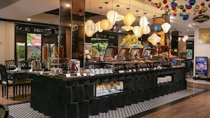 A buffet area with a variety of food items and a coffee station. - Hoi An Golden Holiday Elite (Da Nang)