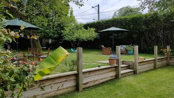 A garden with wooden steps, a bench, and a potted plant.