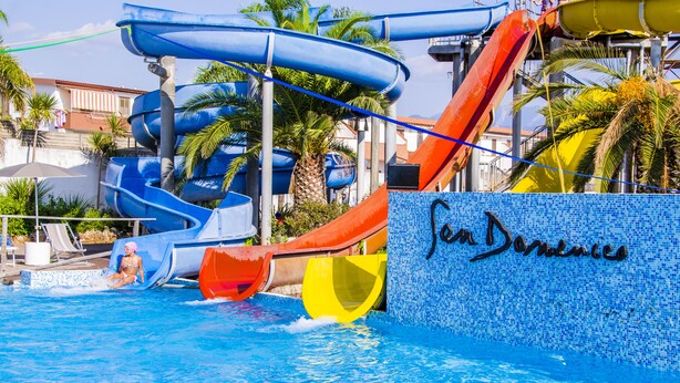 A water park with multiple slides and a pool. - San Domenico Family Hotel (Scalea)