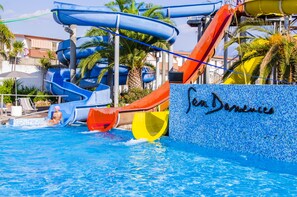 A water park with multiple slides and a pool. - San Domenico Family Hotel (Scalea)