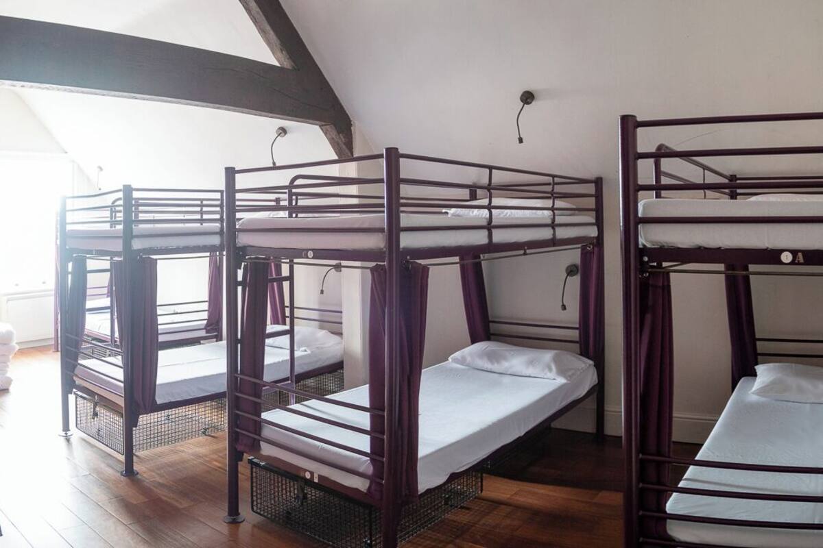 A room with four bunk beds arranged in a row.