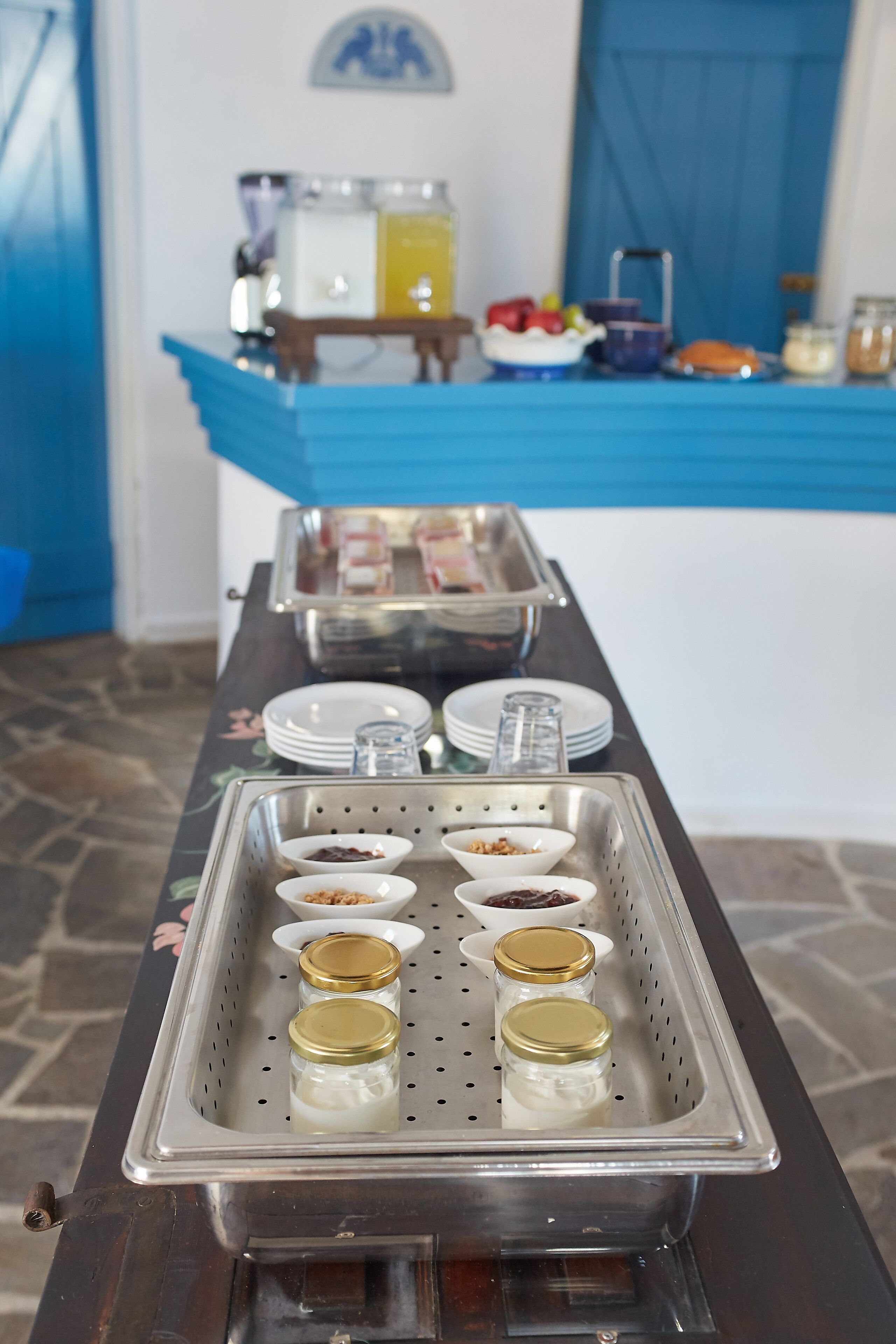 A buffet setup with various food items and condiments.