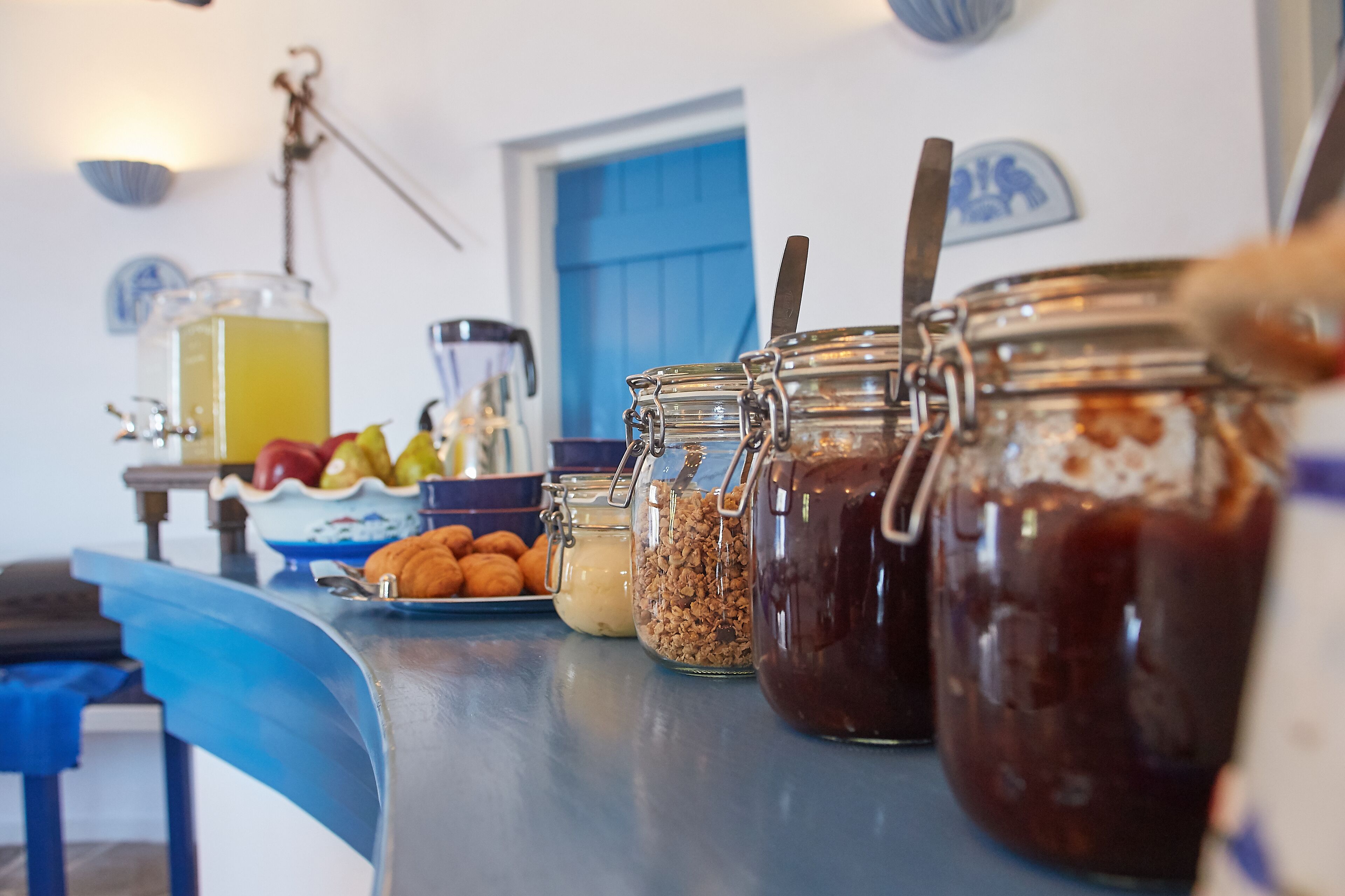 A buffet table with various food items and condiments.