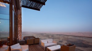A spacious outdoor seating area with a view of a vast landscape. - Beresheet by Isrotel exclusive (Ramat Negev)