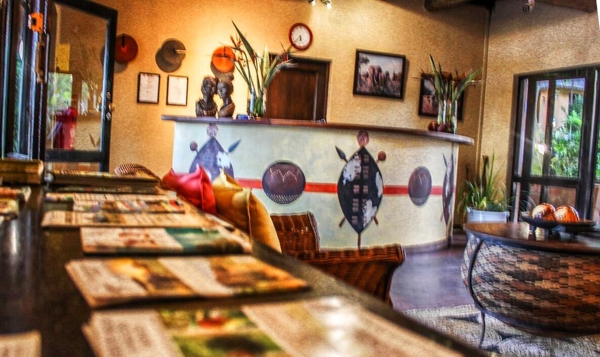 A bar area with a long counter, various seating arrangements, and decorative wall art.