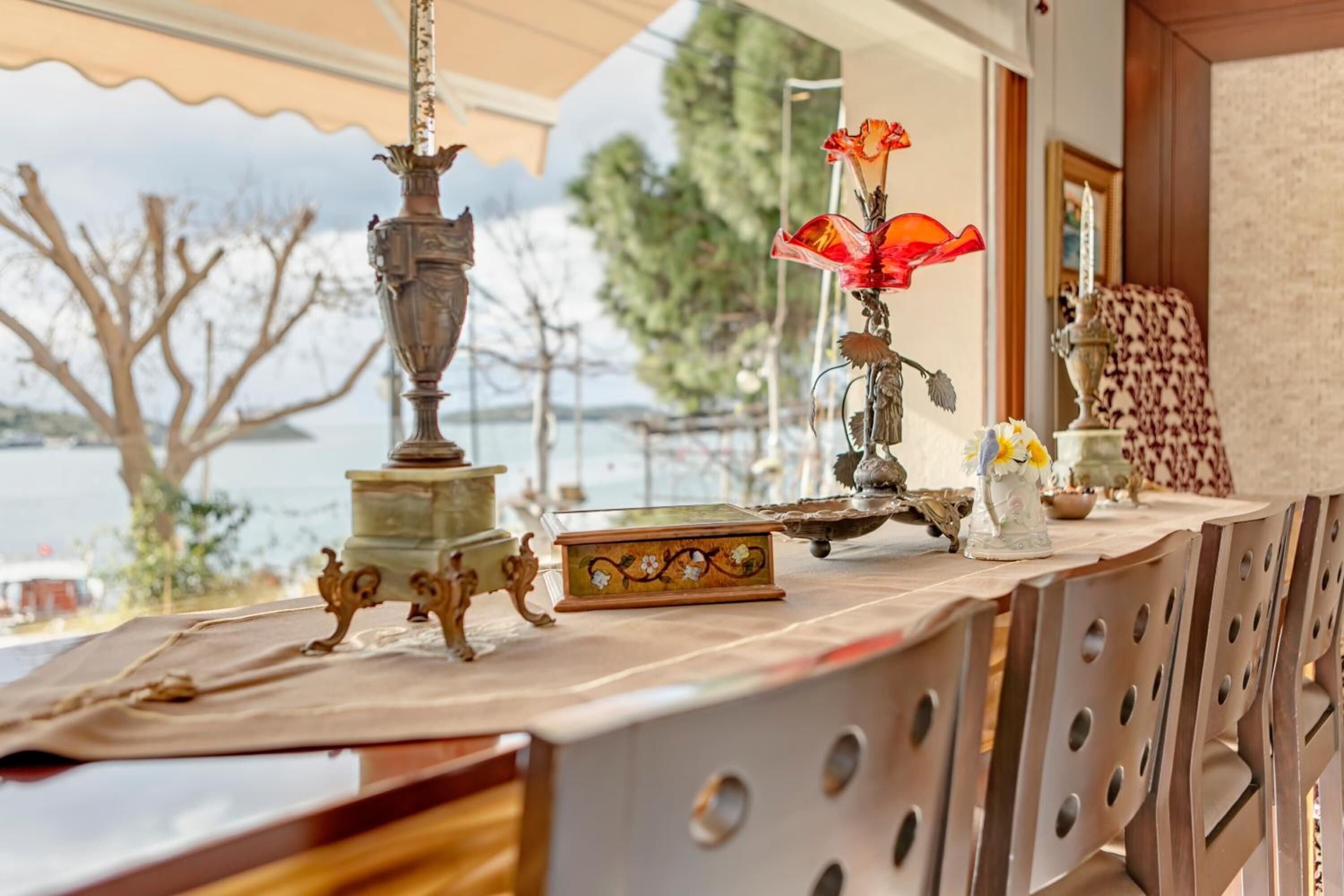 A table with various decorative items, including a vase, a book, and a small sculpture.