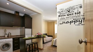 A compact hotel room with a kitchenette, a bed, and a bathroom. - Oporto City Center Apartments (Porto)