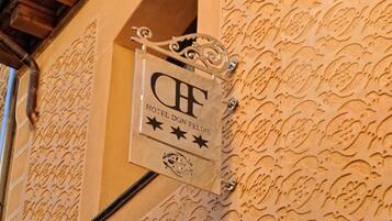 A hotel sign with the name "Hotel Don Felipe" and a decorative wall with intricate patterns.