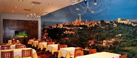 A restaurant with tables set for dining, a television on the wall, and a mural of a cityscape.