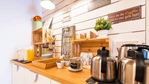 A cafe counter with coffee-making equipment, a sign that says "Fresh Morning Coffee," and various coffee-related items.