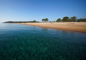 Beach nearby, white sand, beach towels