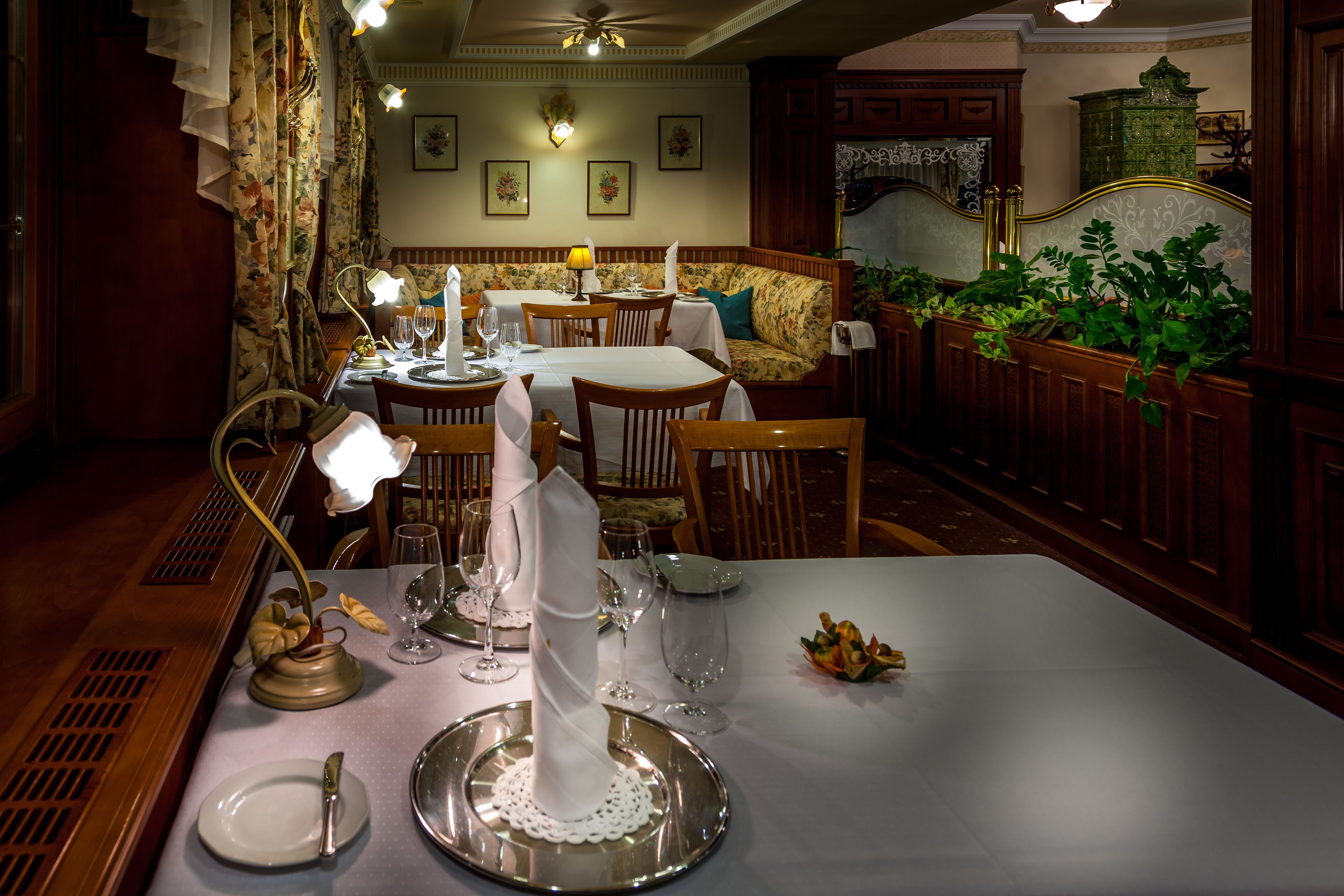 A dining area with a table set for a meal, including plates, cutlery, and glasses.