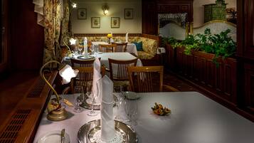 A dining area with a table set for a meal, including plates, cutlery, and glasses.