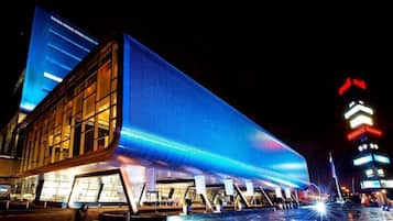 A modern building with a prominent blue facade and a glass entrance.