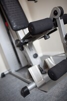 A gym equipment with a bench and adjustable weights.