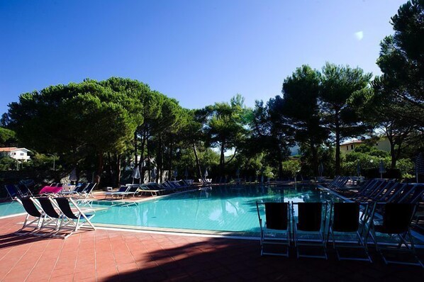 Seasonal outdoor pool, open 9:00 AM to 7:30 PM, pool umbrellas