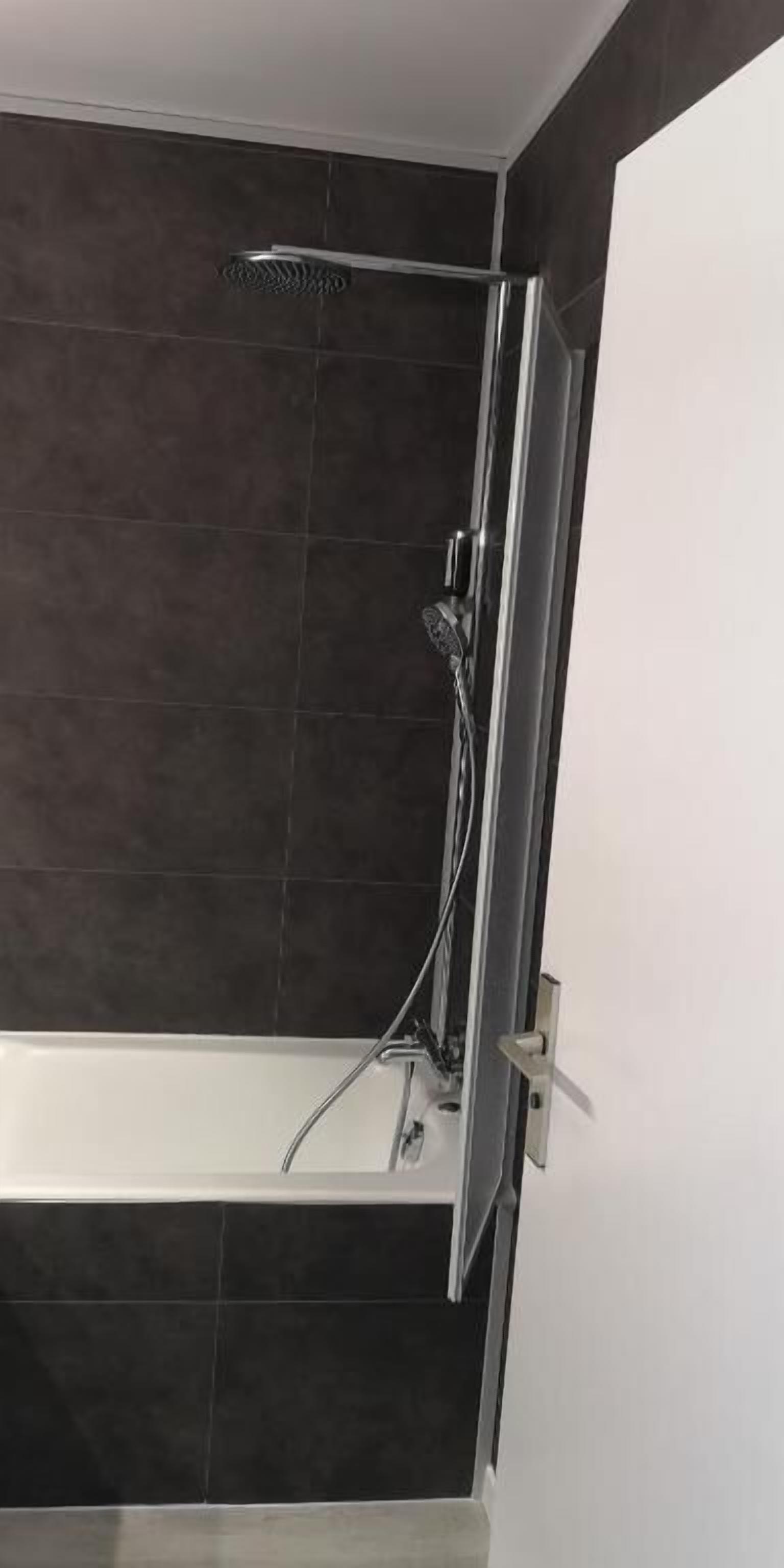 A modern bathroom with a shower and a bathtub.