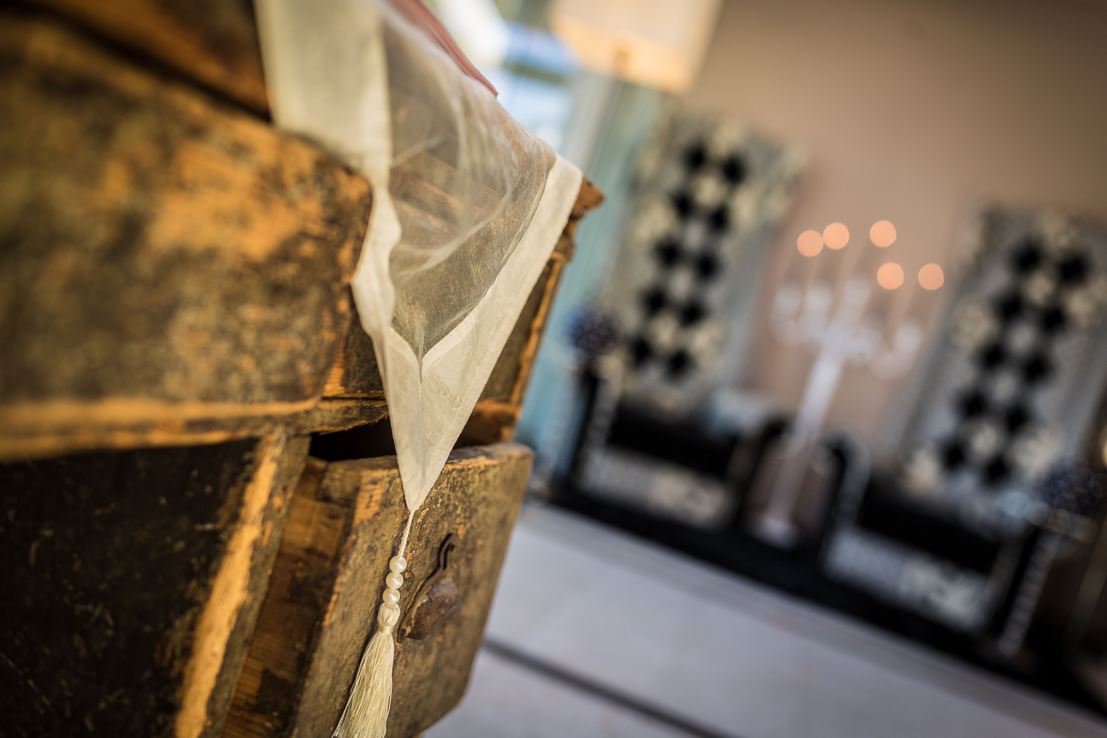 A close-up of a rustic wooden structure with a fabric draped over it, possibly a part of a room or furniture.