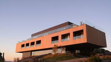 A modern building with a flat roof, large windows, and a minimalist design.