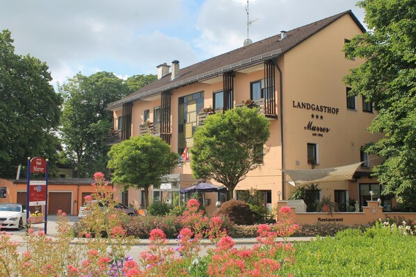 A hotel named Landgasthof Murrer with a sign indicating it is a restaurant.