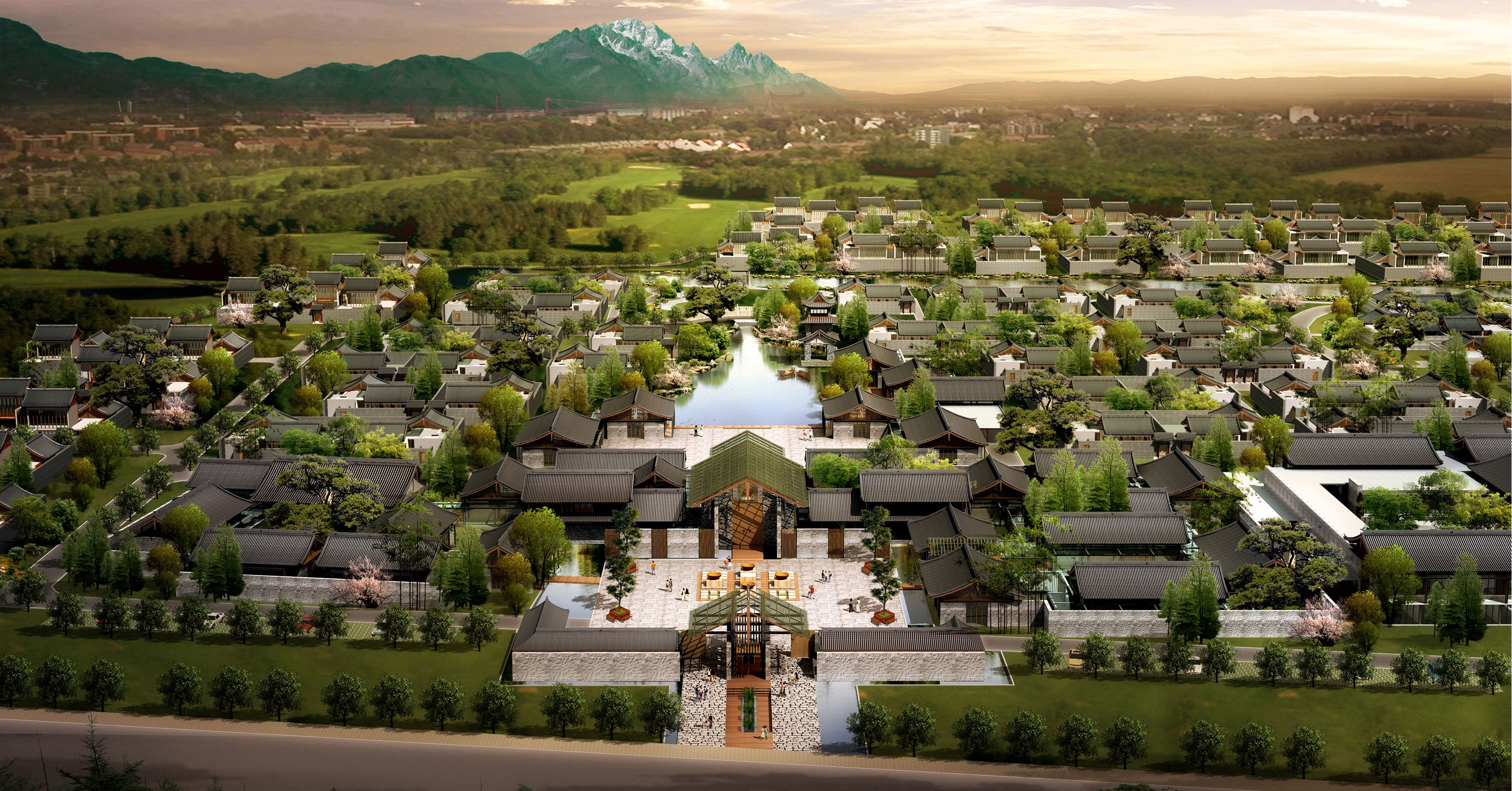 Vue aérienne d’un quartier résidentiel de style traditionnel, avec de nombreuses maisons, une cour centrale et une chaîne de montagnes en arrière-plan.