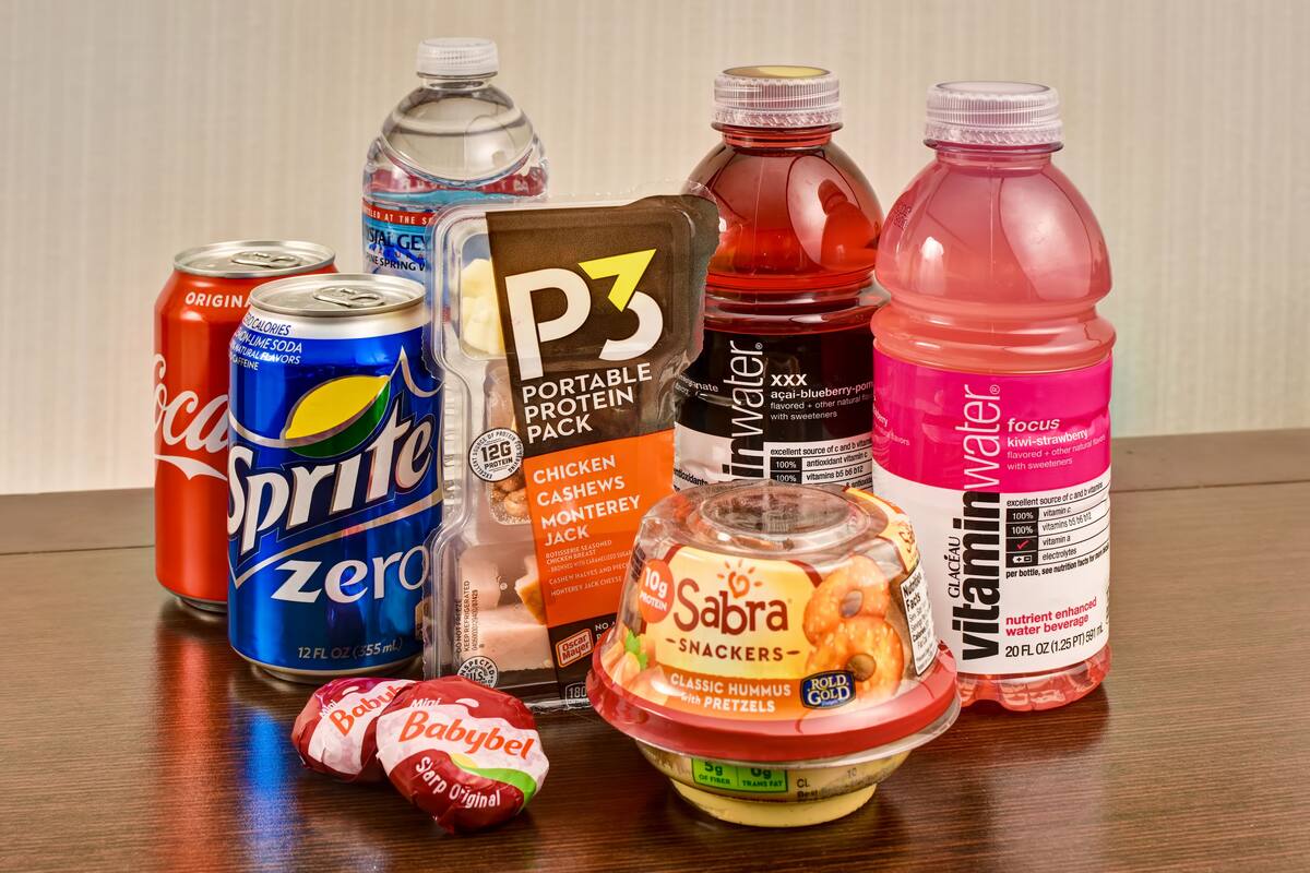 A variety of food and drink items including cans of Sprite Zero, a portable protein pack, Sabra snacks, and vitamin water.