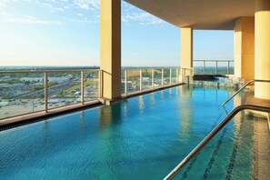An indoor swimming pool with a view of the cityscape. - The Westin Houston, Memorial City (Houston)