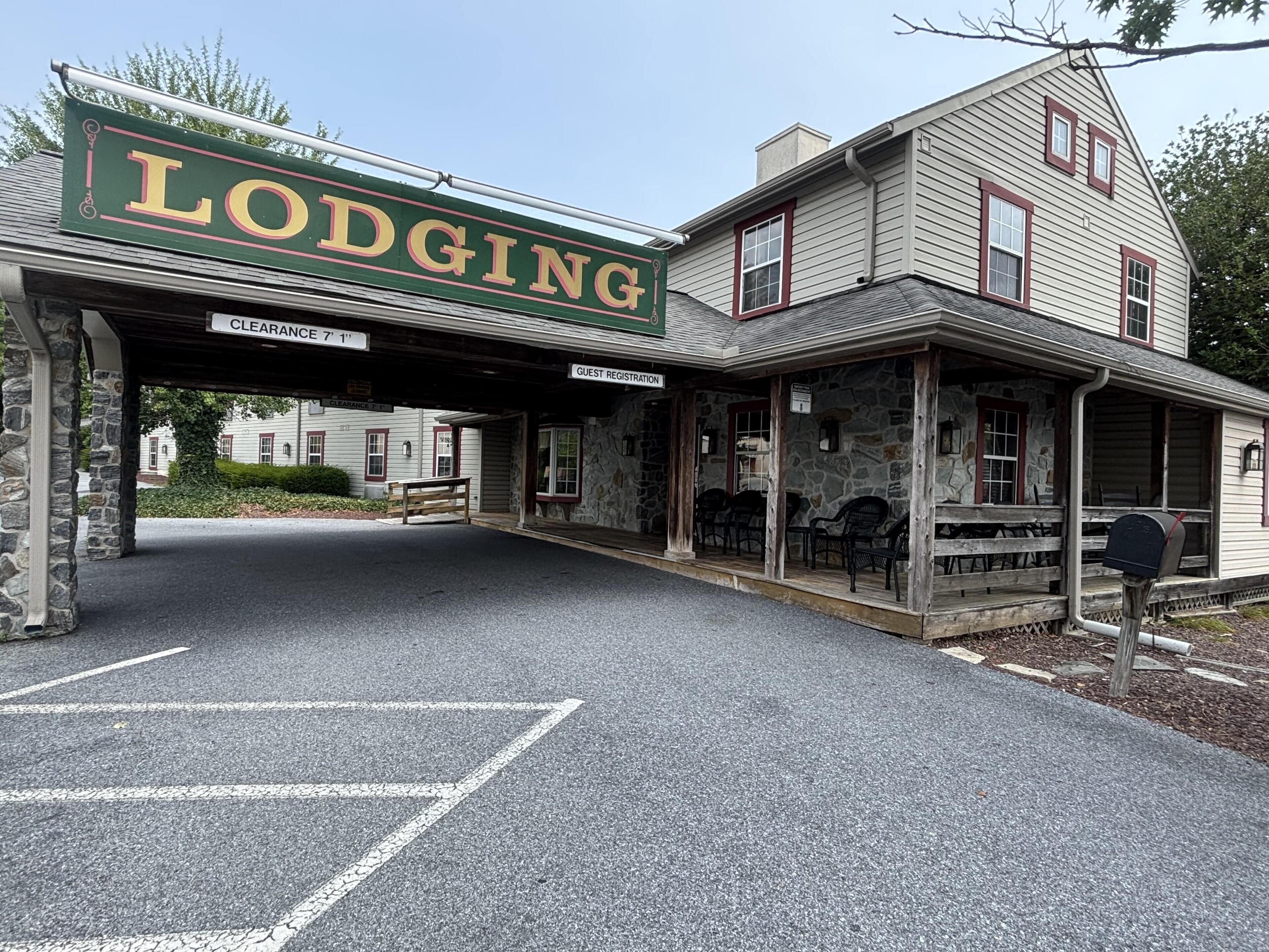A historic building with a sign reading 'Lodging' and a guest registration area.