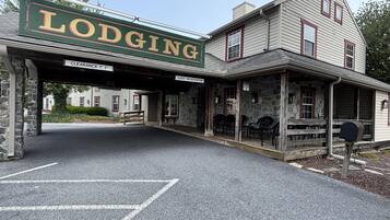 A historic building with a sign reading 'Lodging' and a guest registration area.
