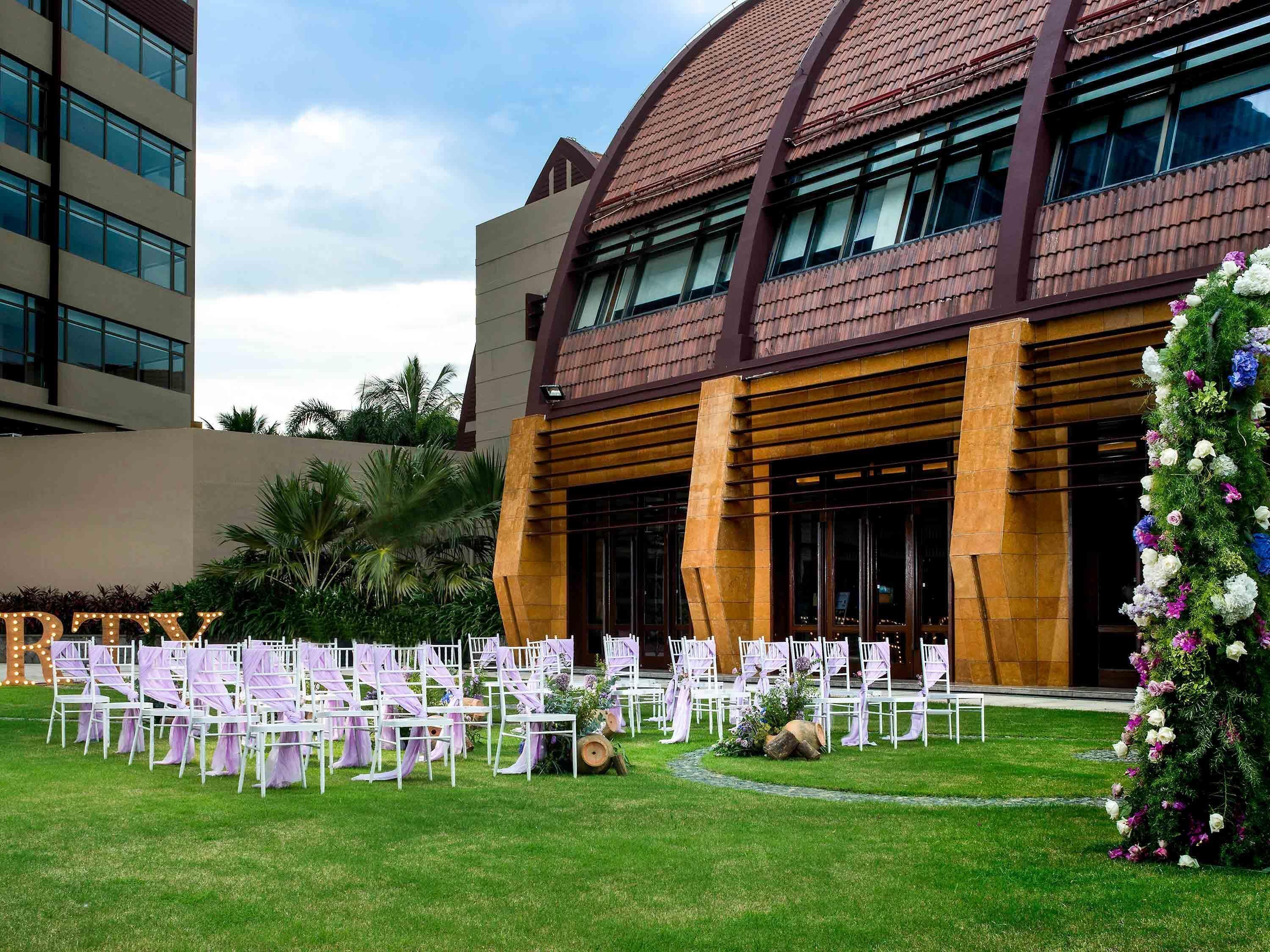 A building with a modern architectural style, featuring large windows and a curved roof.