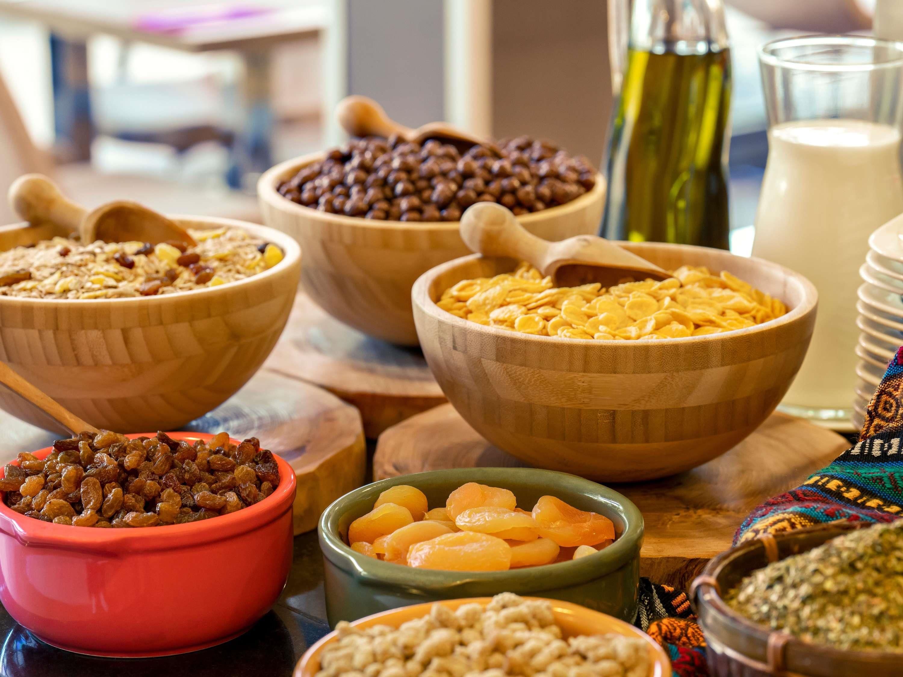 Diversas opciones de comida en cuencos, como cereales, frutas secas y frutos secos.