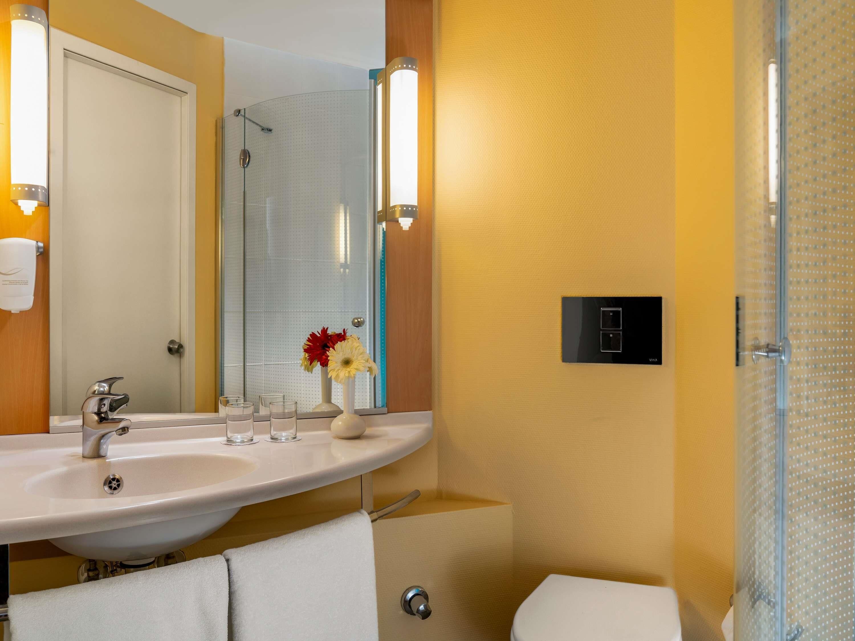 Shower, eco-friendly toiletries, hair dryer, slippers