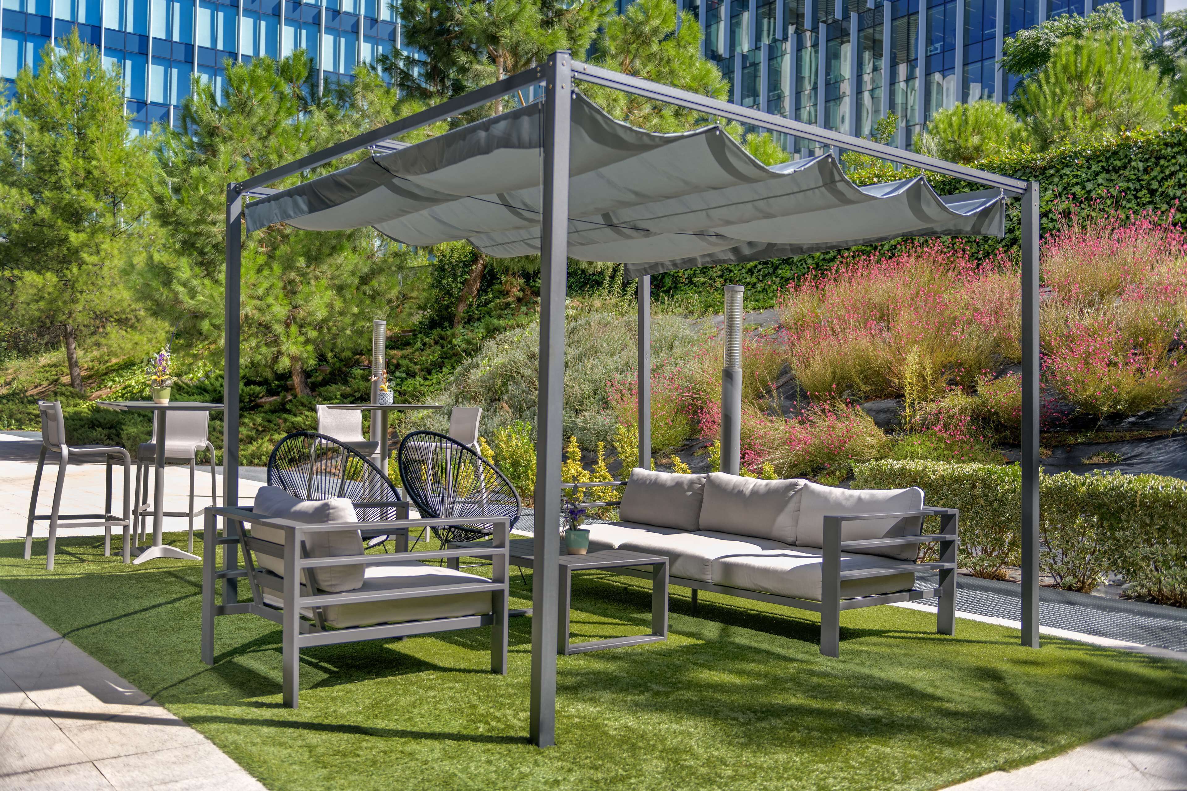 An outdoor seating area with a canopy, a sofa, and a table.