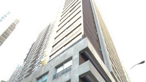 A high-rise building with a sign for 'Central Suites' at the entrance. - RQ Central (Santiago)